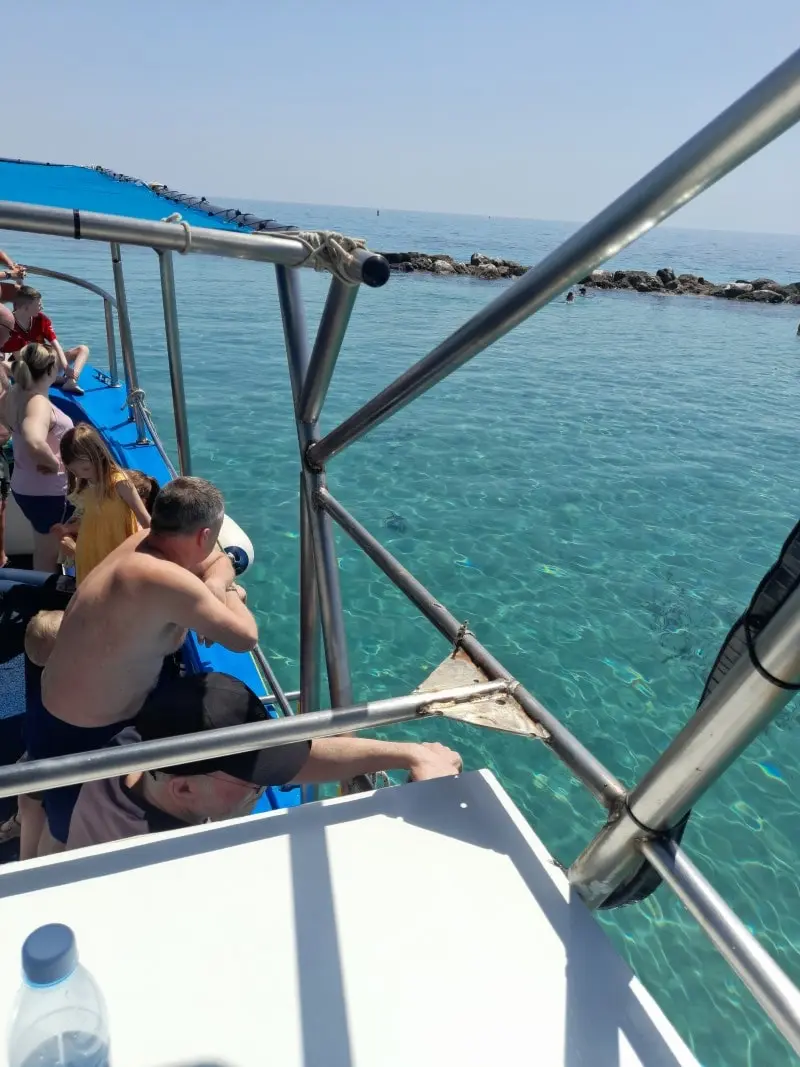 Customers admiring the scenic sea view from the Yellow Glass Bottom Boat in Paphos.